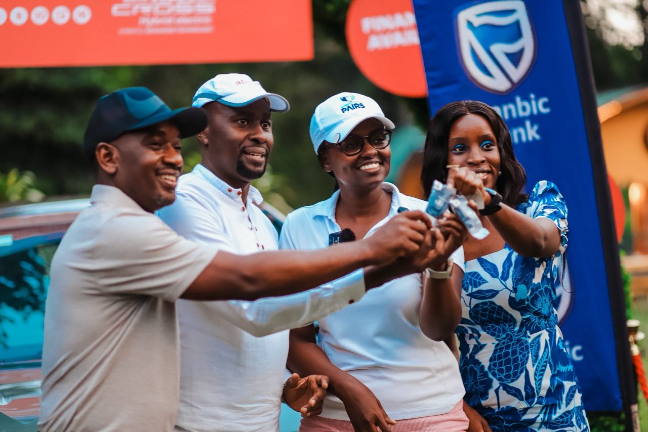 Golfer Berna Musanabera recieving car keys from the CFAO represenative and AfriSafes Andrew Baguma together with Entebbe Golf Club Captain